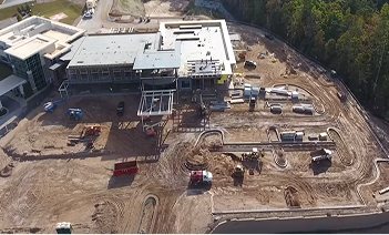 Aerial view of a construction site with heavy machinery and a partially built structure