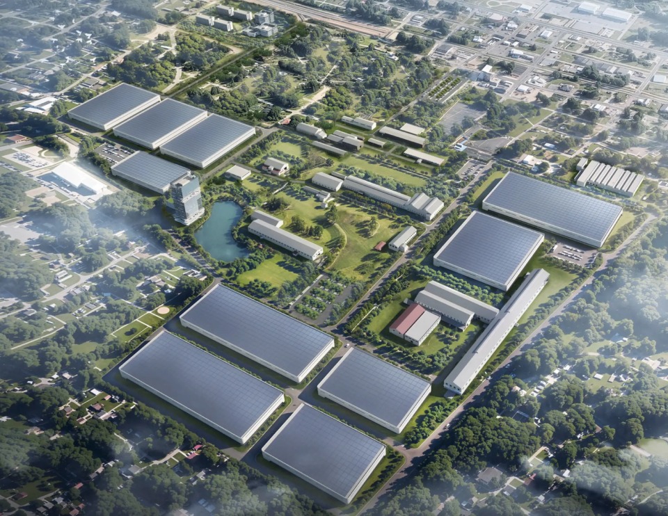 Aerial view of a large industrial complex with green spaces and buildings