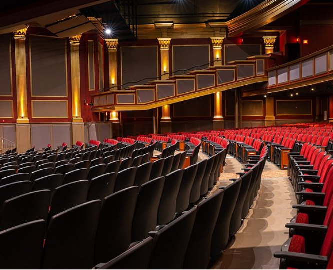 View of an elegant theater interior with red and black seats
